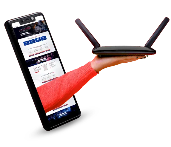 A hand is holding a Wi-Fi router in front of a cell phone. The router is black and has four antennas and the cell phone is black